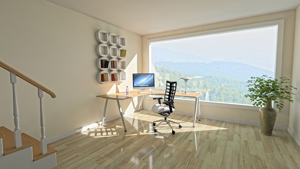 A modern, brightly lit home office with modernist decor and bright white hues