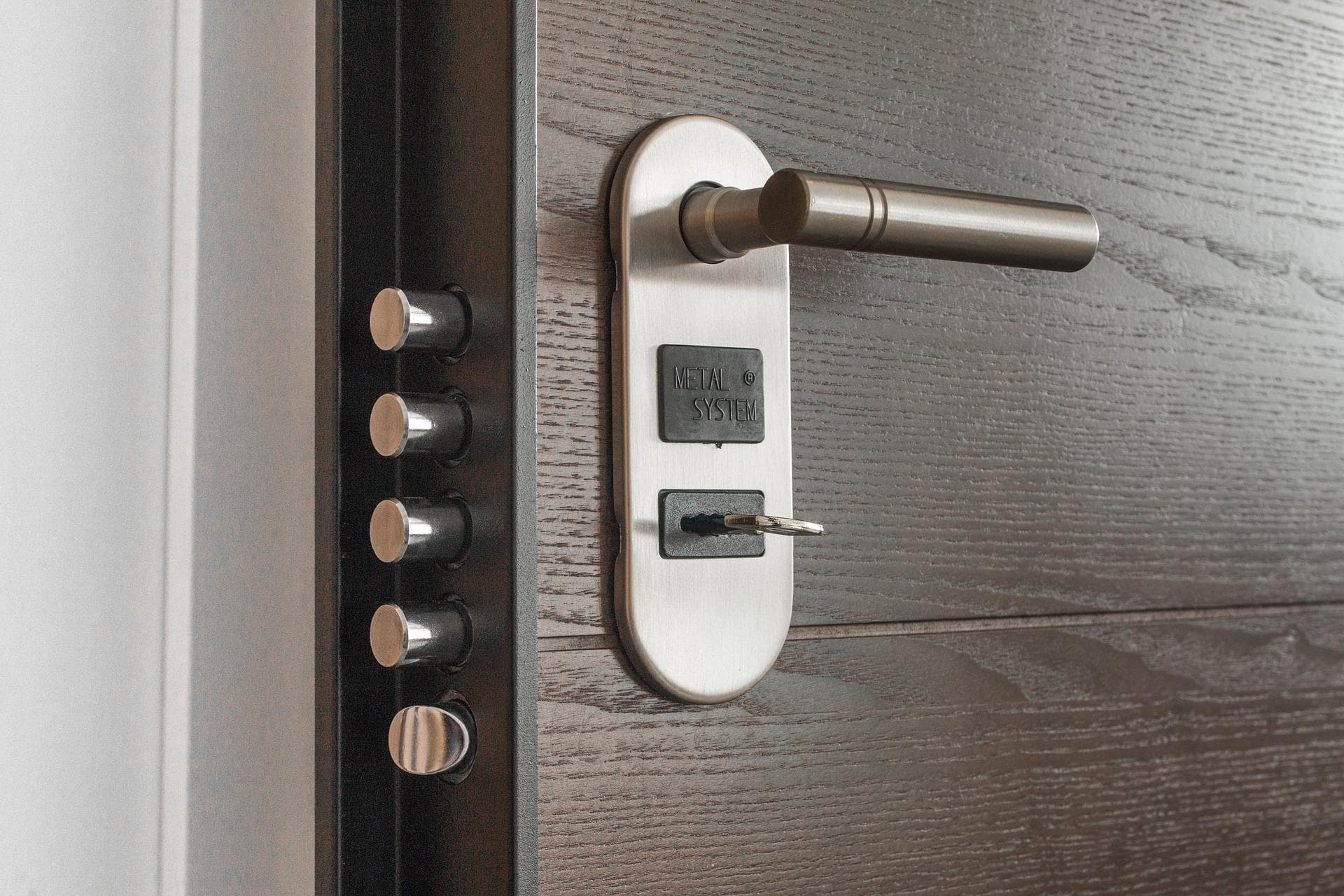 A key in a door with a modern and enhanced lock system.