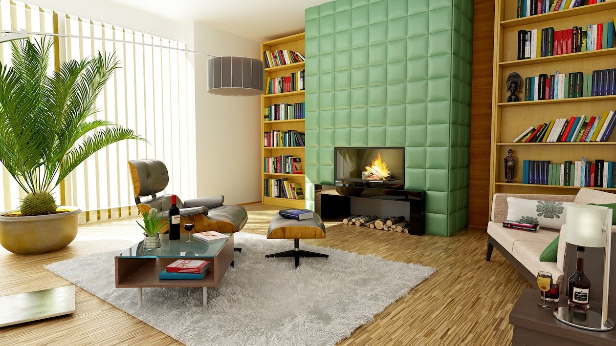 A cozy multifamily smart home rental unit is set with modern colors, bookshelves and lush houseplants.