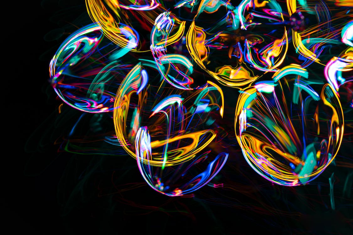 Vivid colors and lights shine on bubble-like spheres.
