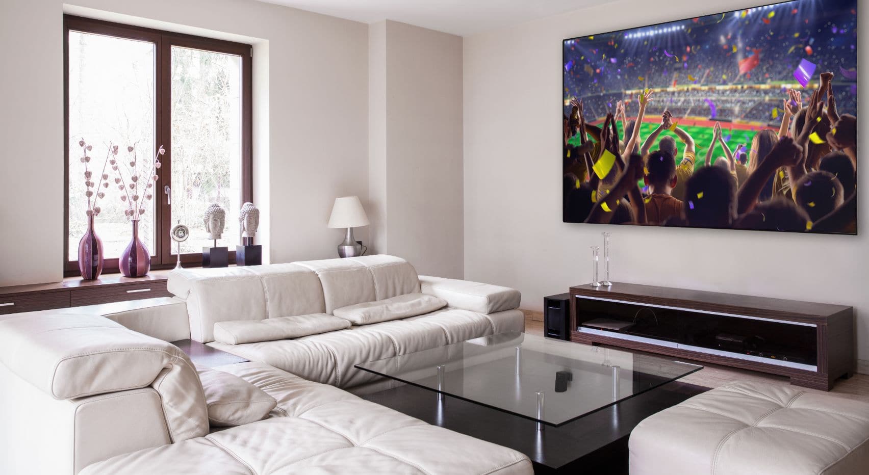 Smart home theater system with large 4K wall-mounted display in a modern living room